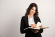 © rastockinc - Positive teacher posing with open notebook