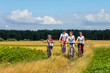 © drotik - family of cyclists  ride outdoors. Happy mother father and kids on bikes cycling outdoors.
