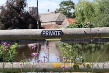 A Sign On A Gate Near The Duck Pond In The Village Of East Quantoxhead In Somerset, Advising People That It Is Private Property