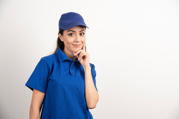 Poster - Pretty woman in blue uniform touch her face with hand