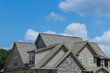 © ungvar - Roof construction of a building roof that is covered with new asphalt shingles