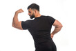© rastockinc - Sportive man in black shirt showing his biceps muscle
