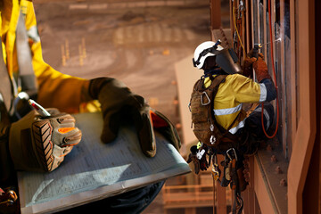 Wall Mural - construction miner supervisor wearing safety glove signing working at height working permit on open 