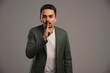 © rastockinc - A businessman in dress code asks to keep silence
