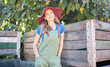 © Jade M/peopleimages.com - Portrait of young female farmer enjoying quiet time outdoors on a sunny day. Happy woman relaxing after picking fresh apples on a sustainable farm, smiling, relaxed and peaceful on an organic orchard