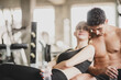 © chokniti - young couple person relaxing in fitness gym, two people training exercise workout together concept