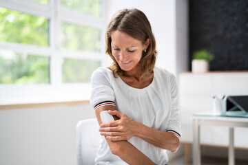 woman applying patch on her arm