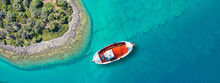 Aerial Drone Top Down Ultra Wide Photo Of Beautiful Red Fishing Boat Anchored In Small Paradise Island Of Monolia In Small Complex Of Lihadonisia With Turquoise Clear Sea, North Evia Island, Greece