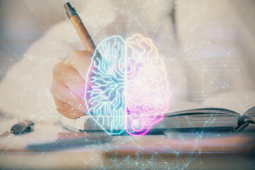  Double exposure of woman's writing hand on background with brain hologram. Concept of brainstorming.