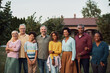 © Drazen - Happy multi-ethnic extended family in backyard looking at camera.