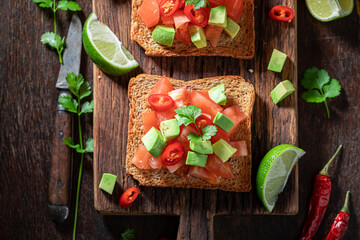 Wall Mural - Vegetarian and hot toasts with avocado, tomatoes and coriander.