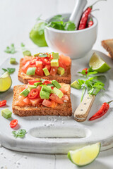 Wall Mural - Homemade and tasty toasts with avocado, tomatoes and coriander.