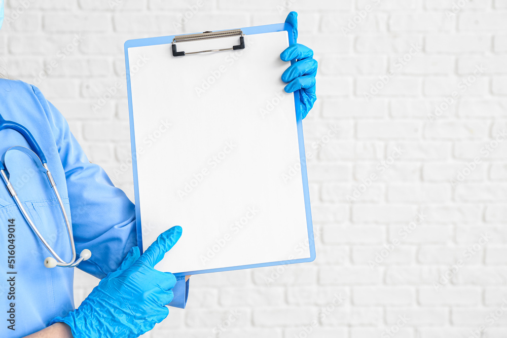 Female doctor with blank clipboard on white background