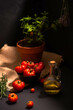 organic garden tomatoes prepared for cooking with olive oil, garlic and rosemary