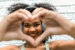 © kanpisut - Woman hold hands together in the shape of a heart. Woman show heart hand symbol