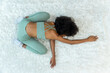 © kanpisut - Woman doing yoga at home in the living room. Woman is stretching in yoga at home. work out time