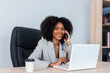 © kanpisut - Beautiful businesswoman working on laptop in bright modern office