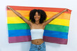 © kanpisut - Young woman holding LGBT rainbow flag. Woman holds a flag of the LGBT community .