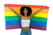 © kanpisut - Young woman holding LGBT rainbow flag. Woman holds a flag of the LGBT community .