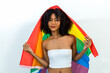 © kanpisut - Young woman holding LGBT rainbow flag. Woman holds a flag of the LGBT community .