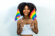 © kanpisut - Young woman holding LGBT rainbow flag. Woman holds a flag of the LGBT community .