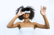© kanpisut - Woman in VR headset. Happy woman using VR glasses for online game