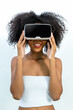 © kanpisut - Woman in VR headset. Happy woman using VR glasses for online game