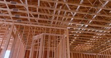New Wooden Building With Wood Beams And Roof Trusses Under Construction Framework