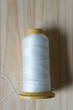 © eugen - spool of thread on a wooden background