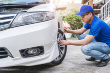Close Up Auto Mechanic Man Checking Car Tire . Car Service. Hands Replace Tires On Wheels. Tire Installation Concept.