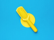 Yellow Comb On A Blue Background With A Yellow Circle. Minimal Hair Care Concept.
