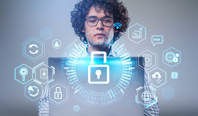 Businessman with laptop, data protection lock with different icons and binary