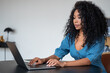 African businesswoman working with laptop on desk in home office