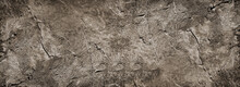 Dark Gray Brown Rock Texture. Rough Mountain Surface With Cracks And Scratches. Close-up. Grunge. Stone Granite Background With Space For Design. Backdrop. Web Banner. Wide. Panoramic.