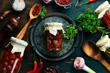 Wall Mural - Marinated dried tomatoes in a glass jar. Italian snacks. Food supplies. Top view.