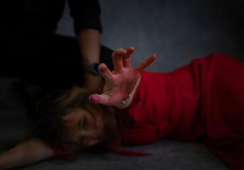 Fototapeta concept of violence against women,crime. bloody hand of female victims in red dress asking for help from being violence