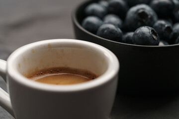 Wall Mural - Espresso with organic blueberries in a black bowl closeup