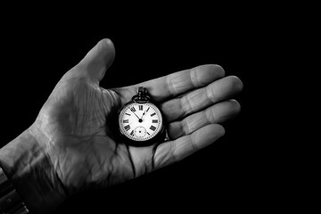 Abstract image Hands of elderly holding pocket watch in retro vintage style back and white color .Concept of man with theirs own time.