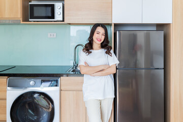 Wall Mural - Image of young Asian woman with fridge