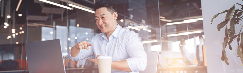 businessman communicating in video call with deaf client at workplace in office. Blurred background
