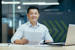 © Liubomir - Portrait of successful asian boss, man with document in modern office smiling and looking at camera, businessman at work