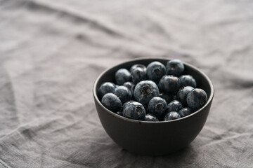 Wall Mural - Freshly washed organic blueberries in a black bowl closeup