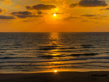 Orange Sea Sunset On The Coast With A Very Beautiful Cloudy Sky