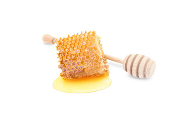 Wall Mural - a piece of beeswax on a white background and a honey stick nearby