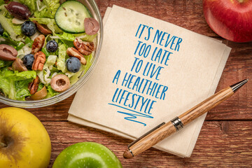 Wall Mural - It's never too late to live a healthier lifestyle, inspirational note on a napkin with green salad and apples