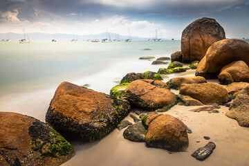 Wall Mural - Beach with boats and sailboats in Jurere long exposure image - Florianopolis, Brazil