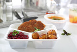 Fototapeta  - Lunch box. Veal schnitzel with baked potatoes and beetroot salad.