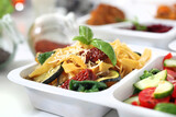 Fototapeta  - Dietary catering. pasta with zucchini, sun-dried tomatoes and spinach. Meal prep.
