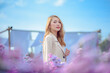 attractive asain woman in white dress relaxing and enjoying in blooming margaret flower field at evening