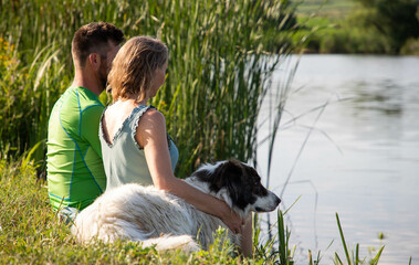 Poster - couple sitting by beautiful lake in the summer